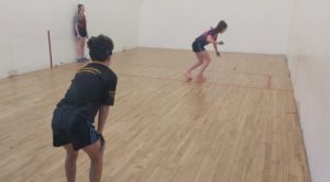 U14/15 League -Jennifer Nicholas, Tulla, serves to Mici Sheedy (centre), Tuamgraney, while her partner Aoife Dooley (left) watches on